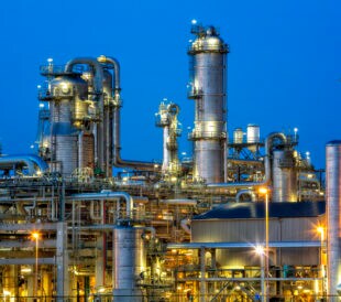 Petrochemical plant illuminated at twilight