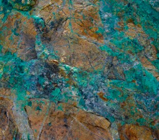 a rock showing signs of copper and gold.