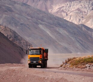 Mining truck on a dirt road in the Andes, Chile (near Embalse El Yeso, Cajón del Maipo, San José de Maipo)