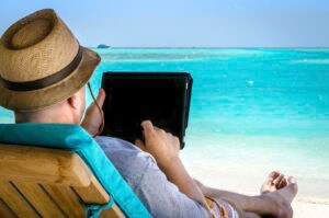 Man holding tablet during vacation on the beach