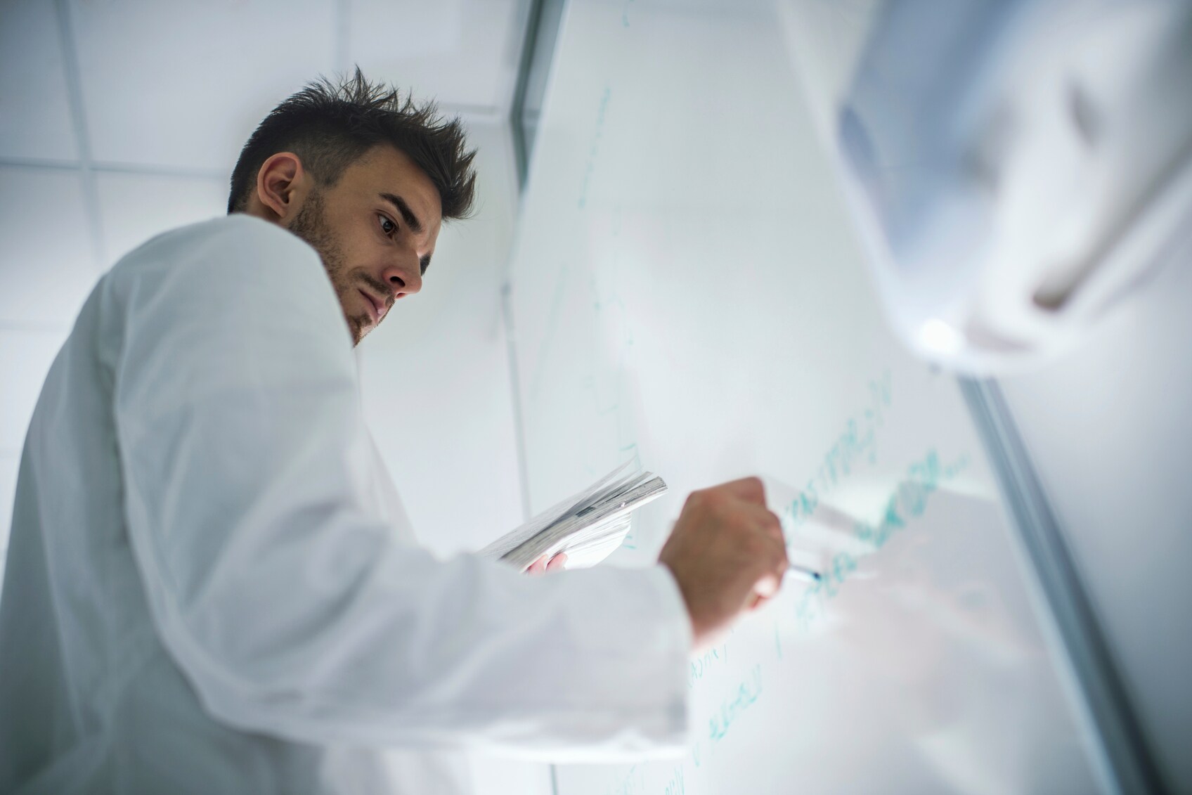 scientist at whiteboard