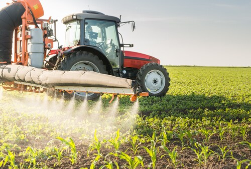 Tractor spraying pesticides on soy bean. Image: Fotokostic/Shutterstock.com.