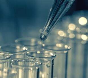 Pipette adding fluid to one of several test tubes. Image: motorolka/Shutterstock.com.