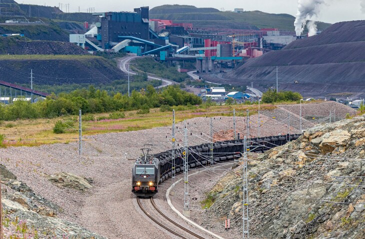 electric iron ore train passing mine operations
