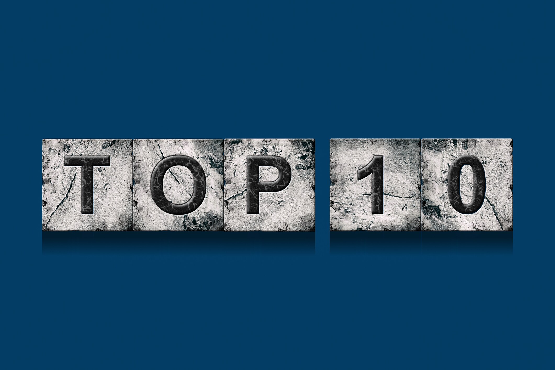 Top 10, words, isolated on a dark blue background. Alphabet on stone blocks.Rating. Rating concept. Background.