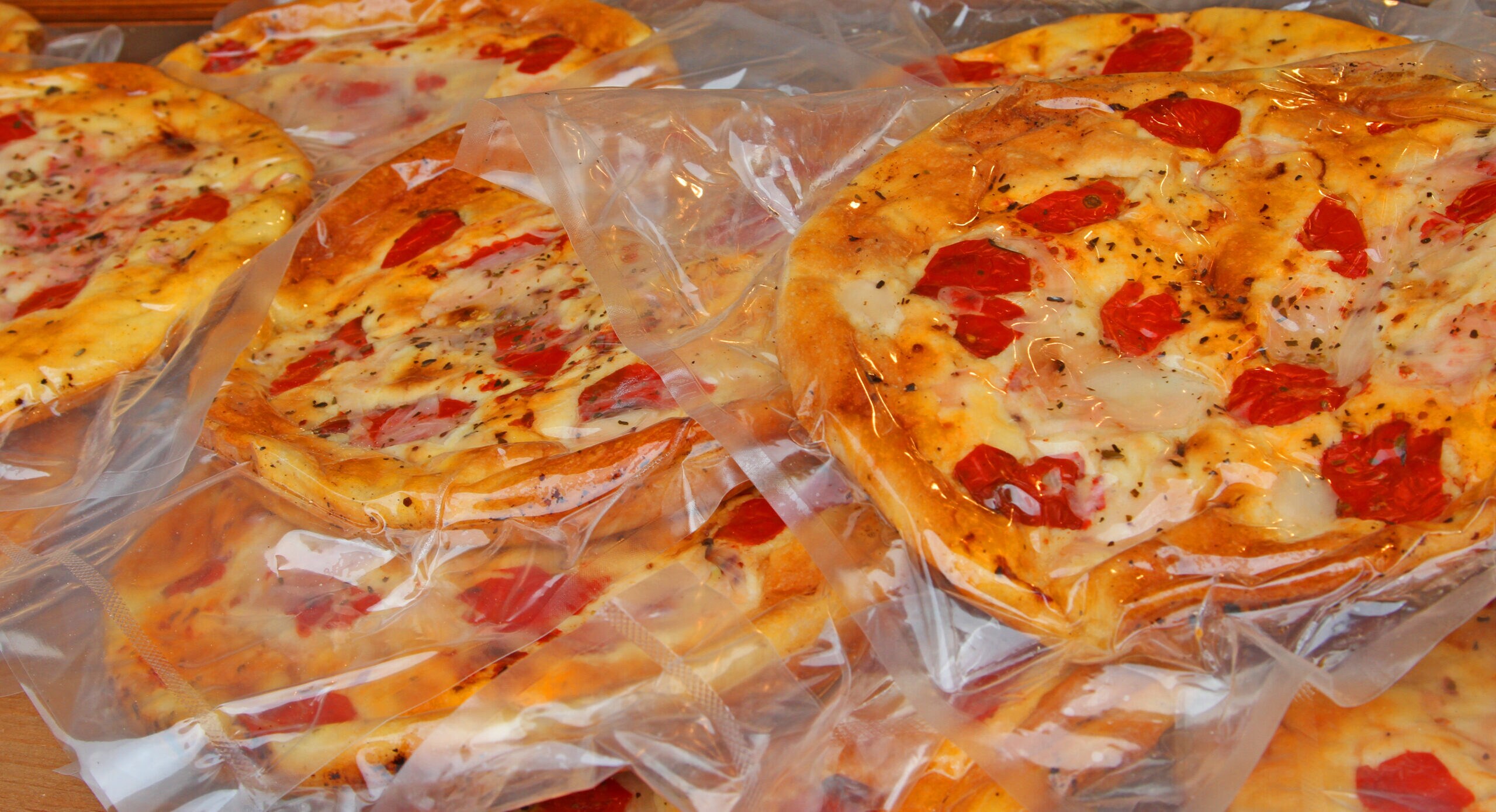 craft delicious pizzas packaged for sale at the market of southern Italy