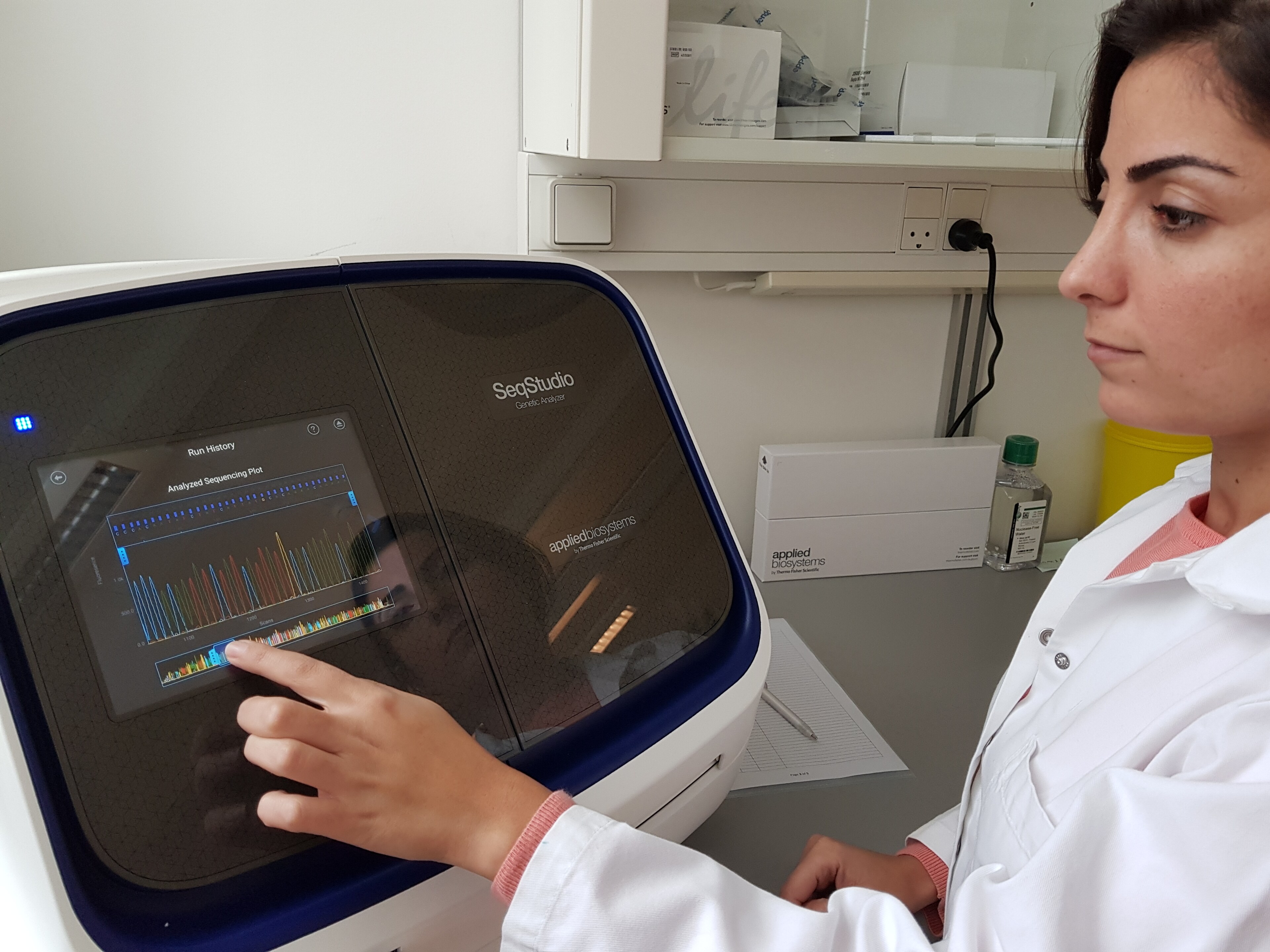 A scientist uses the SeqStudio Genetic Analyzer