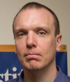 Dr. Brendan Keating, who studies the genetic underpinnings of organ transplants, looks at the camera.