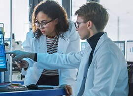 Analytical Services Two scientists looking at cell culture data