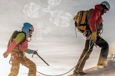 Two mountain climbers approach the peak Two mountain climbers approach the peak