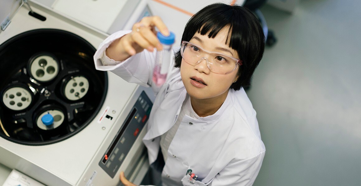 Scientist looking at sample in lab Scientist looking at sample in lab