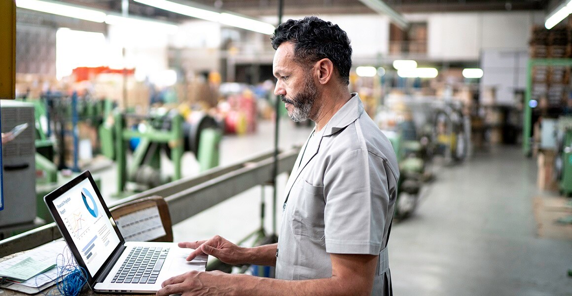 manufacturing card crop man using SampleManager LIMS software on factory floor