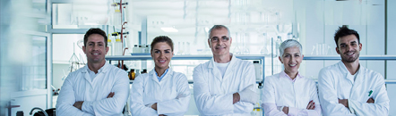 Collaborative team of R&D scientists Team of scientists standing in a lab with benchtop equipment