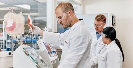 optimizing manufacturing process scientists performing cell therapy production process in lab