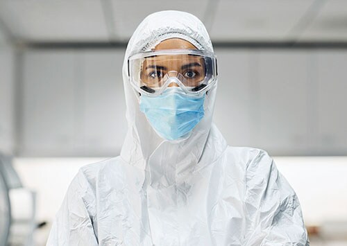Manufacturing scientist in full PPE Manufacturing scientist in full PPE supporting gene therapy commercialization