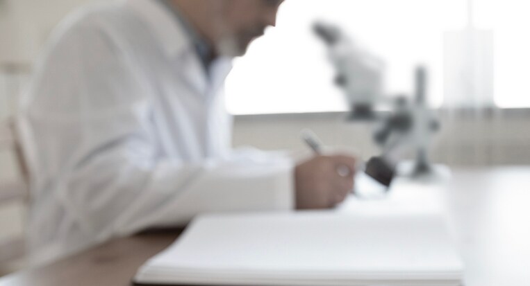 Laboratory researcher working with a microscope Laboratory researcher working with a microscope