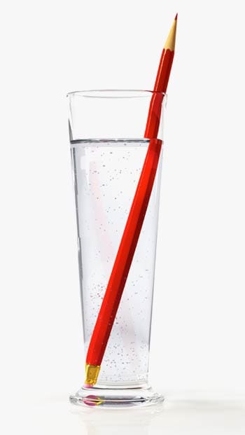 Photograph of a pencil partially submerged in a glass of water Photograph of a pencil partially submerged in a glass of water