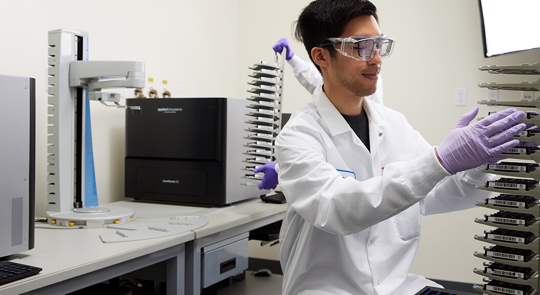 Scientist in lab preparing dPCR automated run Scientist in lab preparing dPCR automated run