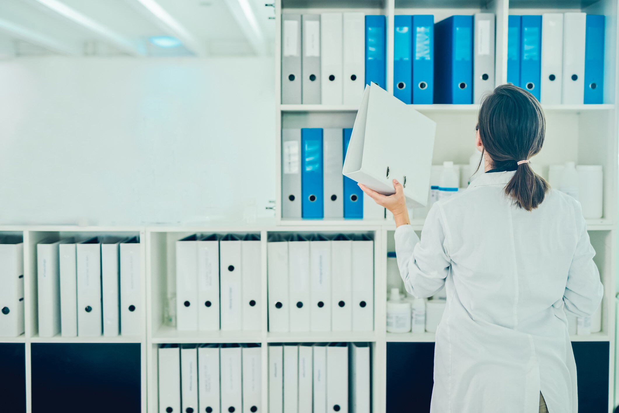 Essential 2 – Compliance and Validation A woman managing a documentation or filing process